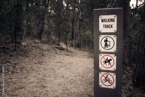 A walk in the forest on lonely track with walking sign