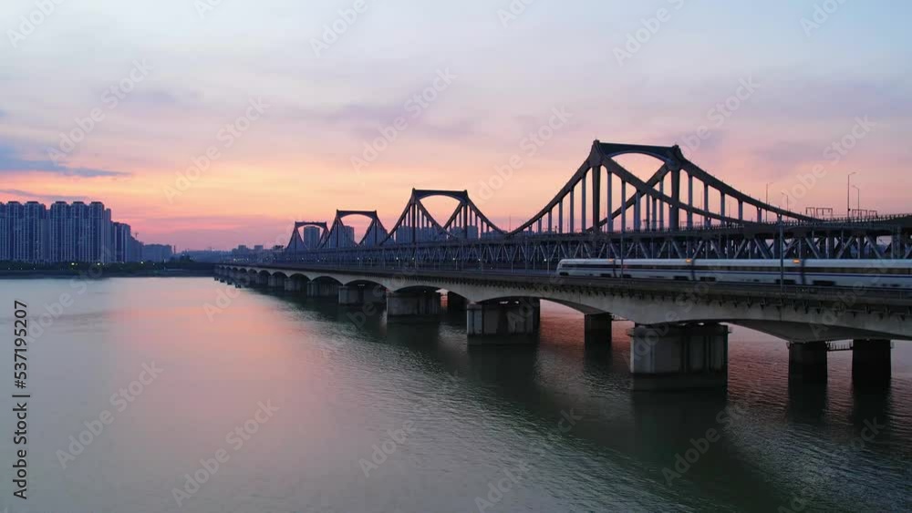 high speed train through bridge over qiantang river at twilight high speed train through bridge over qiantang river at twilight