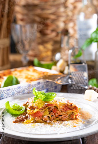 Lasagna with pesto.Italian lunch homemade green lasagna with spinach in the dough  ragu - meat sauce  bechamel and parmesan cheese. illage dining atmosphere in Italy. Copy space