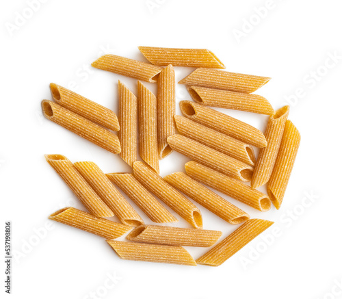 Uncooked whole grain pasta isolated on white background. Raw penne pasta.