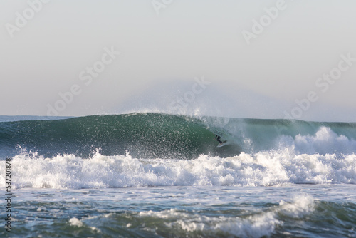 surfer getting barrelled on a wave