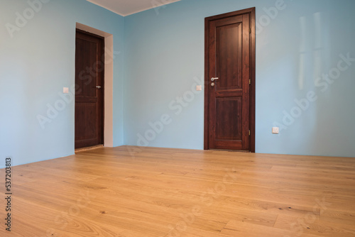 New home construction interior room with wooden floors and wooden doors