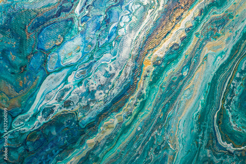 Abstract fluid art background. Turquoise, golden and white ocean, marble effect texture. Close-up of an acrylic painting on canvas.