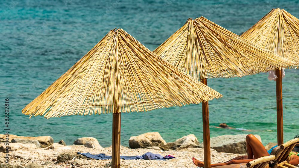 Parasol on a beach by the sea in beautiful vacation weather