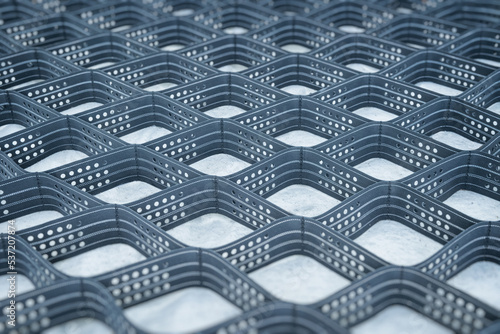 Polymeric geogrid for slope reinforcement. Grid of cells for filling with soil or stones.
