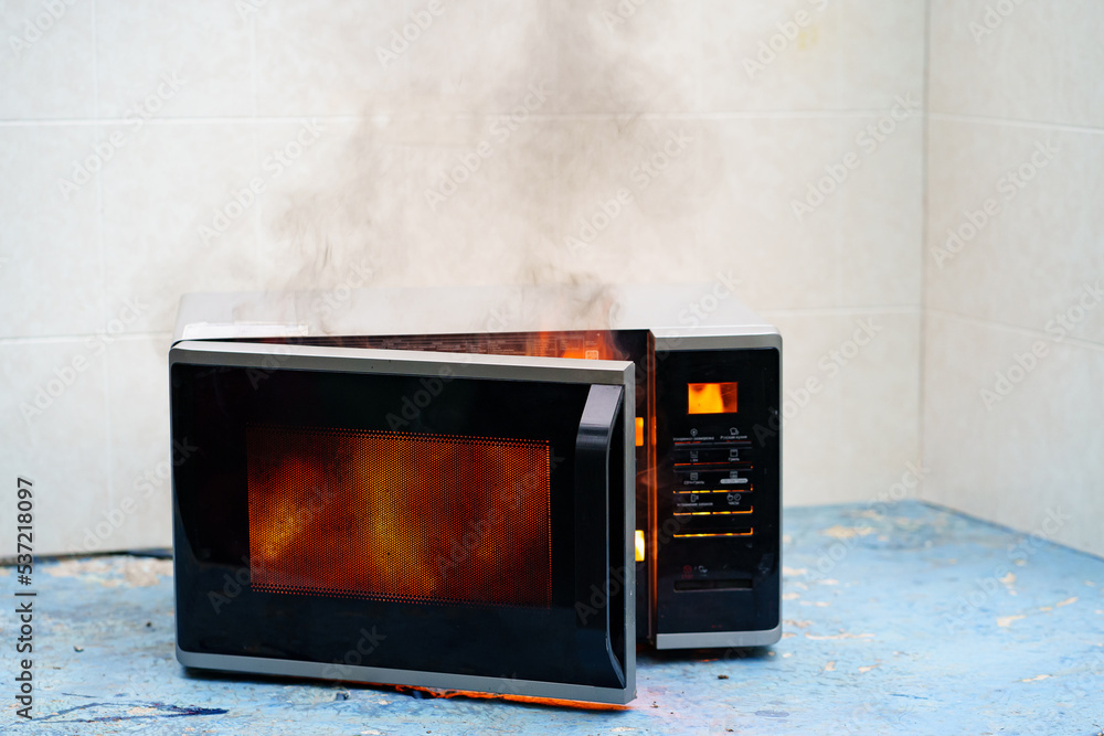 microwave oven on fire. the concept of fire in the kitchen and