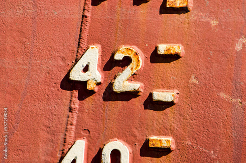 Close-up of the draught marks on a weathered ship's hull, focussing on the number 42 photo