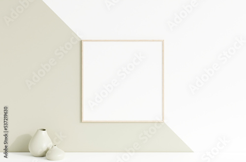 Clean and minimalist front view square wooden photo or poster frame mockup hanging on the wall with vase. 3d rendering.