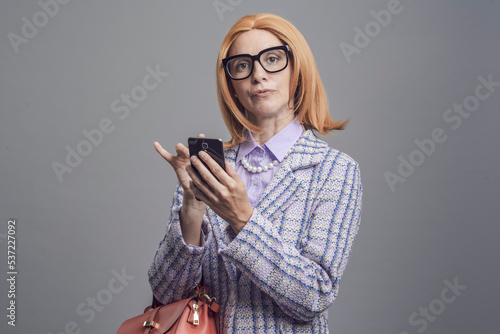 Snobbish lady using her smartphone photo