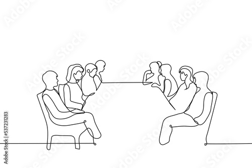 people sit on both sides of a long table and look at each other - one line drawing vector. concept of negotiations, debate