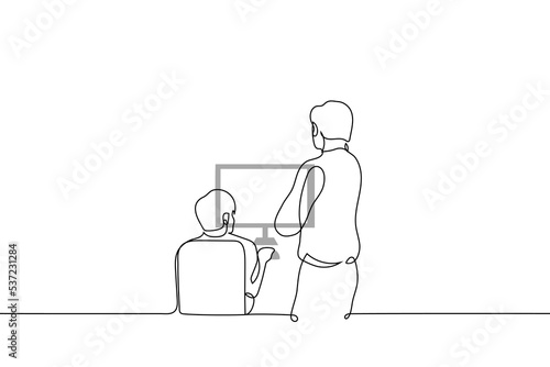 man stands behind a man and looks at his computer screen - one line drawing vector. concept boss or mentor oversees the process of work or task completion by a subordinate or student