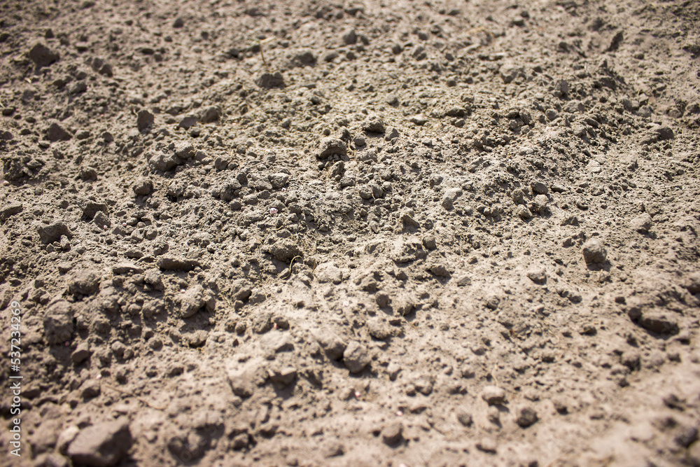 closeup grey-brown soil and sand with texture against blurred background closeup grey-brown soil and sand with texture against blurred background