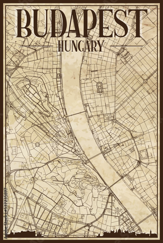 Brown vintage hand-drawn printout streets network map of the downtown BUDAPEST, HUNGARY with brown 3D city skyline and lettering