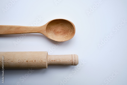 Wooden spoon and rolling pin on a light background. Kitchenware. Cooking concept 