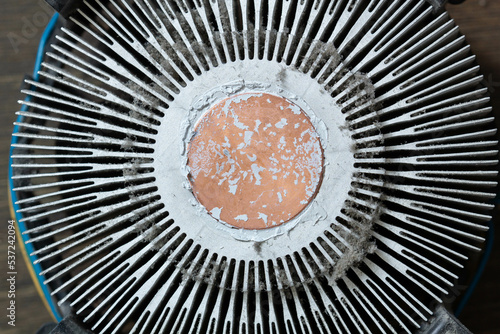 Very dirty cooling radiator for a computer processor. Dusty aluminum cooler for a CPU microchip on a computer motherboard with traces of cooling grease. The part for cleaning. Service electronics