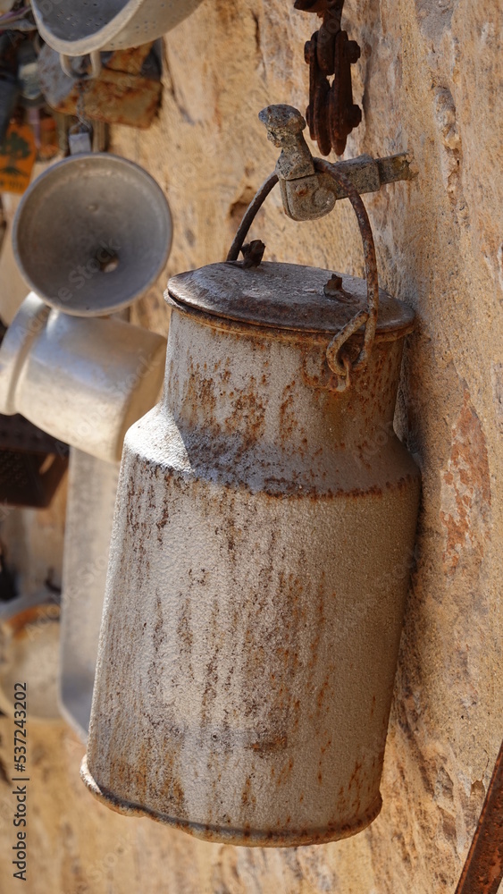 A rusty can hanging on the wall. Zichron Yakov. Israel. Vertical Photo A rusty can hanging on the wall. Zichron Yakov. Israel. Vertical Photo