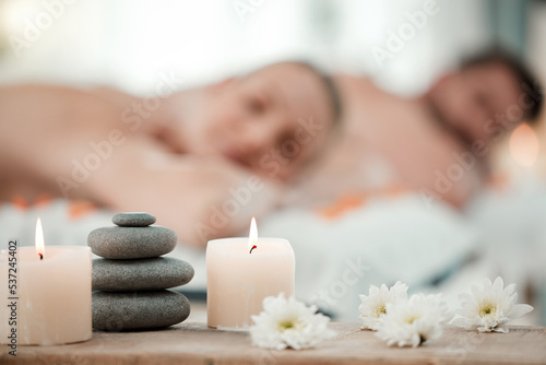 Background of aromatherapy candles, spa and couple luxury skincare, zen wellness and relax body at vacation salon. Closeup of massage stones, calm space and holistic beauty service for stress relief
