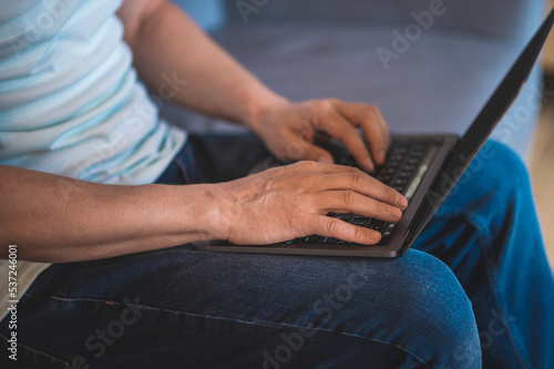 Close up of mans hands holding lapotp
