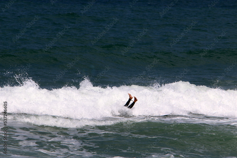 Surfing on high waves on the Mediterranean Sea in northern Israel. Surfing on high waves on the Mediterranean Sea in northern Israel.