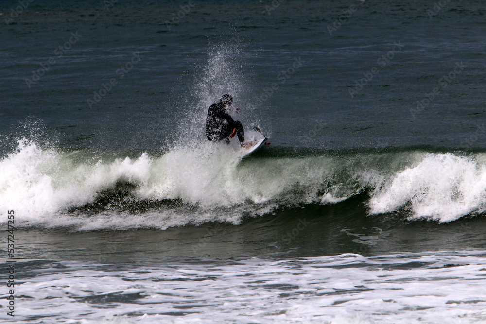 Surfing on high waves on the Mediterranean Sea in northern Israel. Surfing on high waves on the Mediterranean Sea in northern Israel.