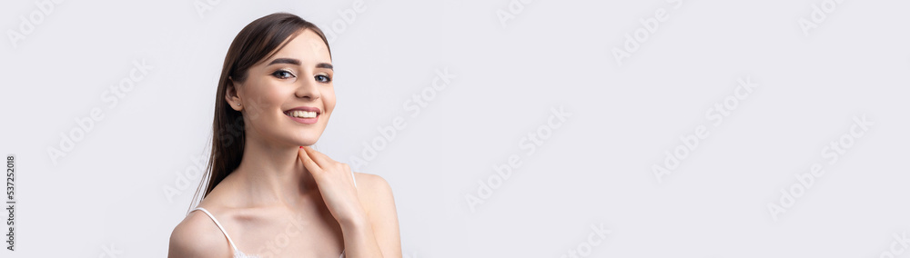 Beautiful smiling woman with clean skin, natural make-up and white teeth on a gray background Beautiful smiling woman with clean skin, natural make-up and white teeth on a gray background