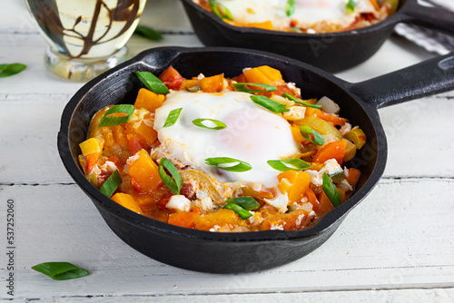 Wallpaper Mural Shakshouka in frying pan. Fried eggs with vegetables, tomato, pepper, pumpkin and onion Torontodigital.ca