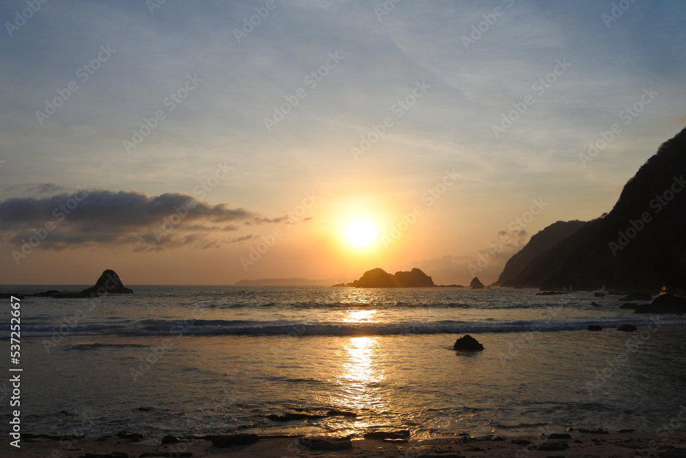 Golden sunset moment at Ppauma beach in Jember, East Java, Indonesia. Papuma beach is the famous beach in Indonesia.