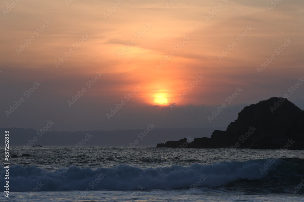 Golden sunset moment at Ppauma beach in Jember, East Java, Indonesia. Papuma beach is the famous beach in Indonesia.