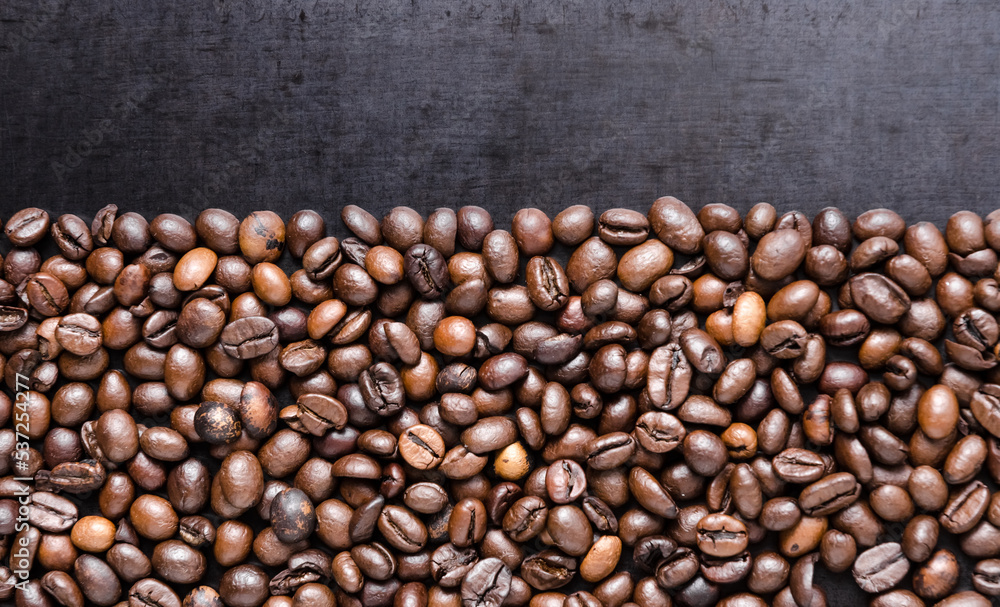 Fototapeta premium Coffee beans on dark background, close-up still life copy space for text
