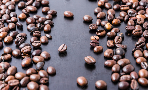 Loose coffee beans on dark background  close-up still life