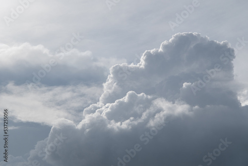 White curly clouds on a gentle blue sky.