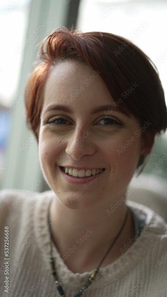Portrait of a young red hair woman smiling at camera in vertical video. Happy 20 girl face SS Portrait of a young red hair woman smiling at camera in vertical video. Happy 20 girl face SS