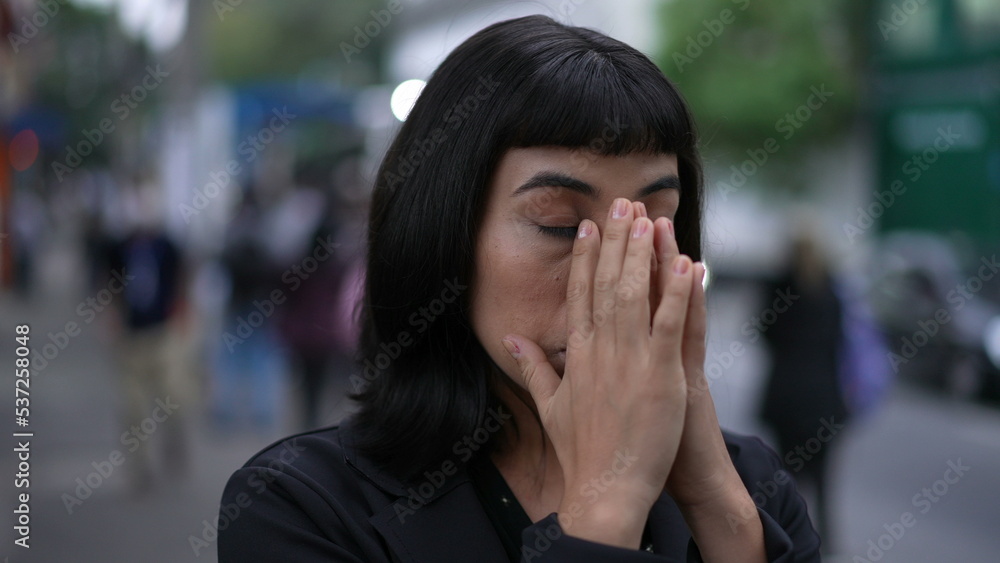 Nervous young woman standing in street feeling anxiety and stress. South American latin adult girl being preoccupied closeup face in urban setting Nervous young woman standing in street feeling anxiety and stress. South American latin adult girl being preoccupied closeup face in urban setting