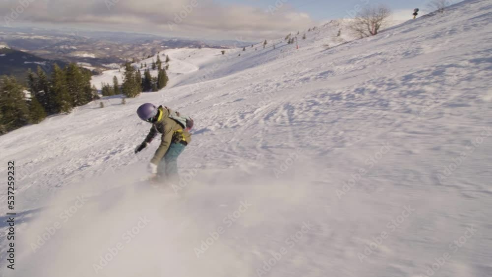 girl snowboarding on slopes. female snowboarder in european ski center. side view. girl snowboarding on slopes. female snowboarder in european ski center. side view.