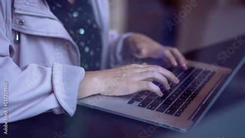 Closeup woman hands typing on computer laptop. Person working remotely with laptop closeup female hand