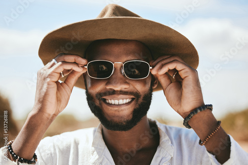 Vision, style or fashion sunglasses for black man with designer, trend or cool optometry eye care. Zoom, smile or happy face of tourist, model or student on safari travel in Kenya nature environment