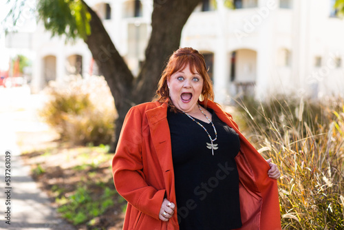 Happy middle age woman with look of delight or shock on face photo