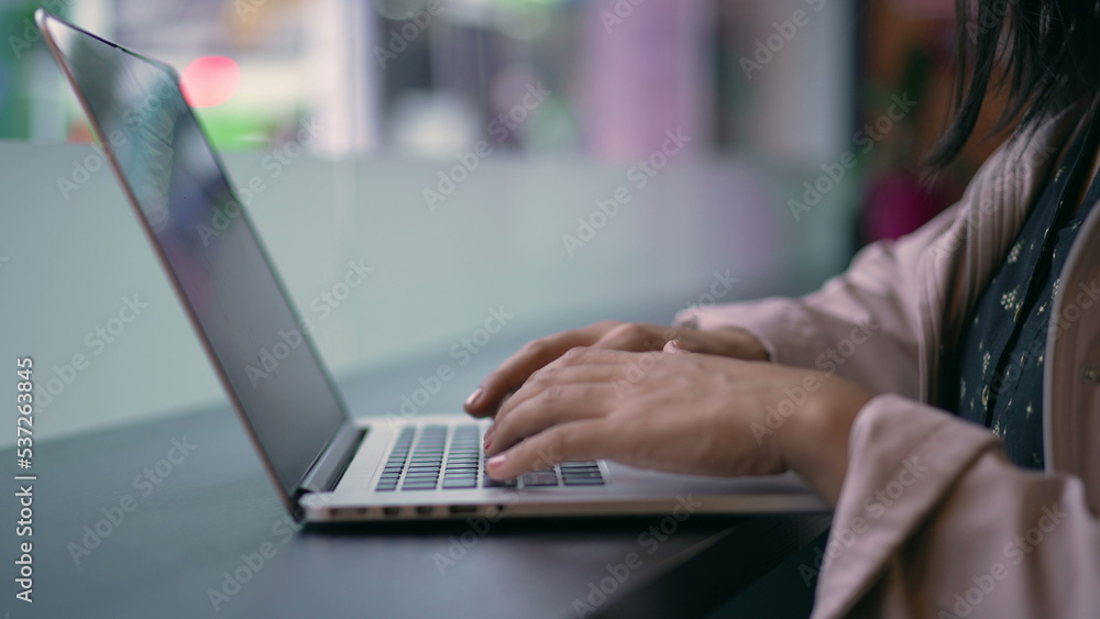 Fototapeta premium One young hispanic woman opening laptop in coffee shop remote workplace. South American Brazilian girl using computer typing in keyboard