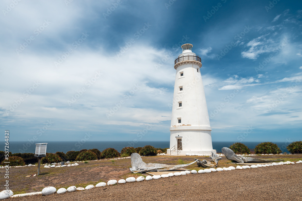 Cape Willoughby Lighthouse against blue sky with clouds on a bright day, Kangaroo Island, South Australia