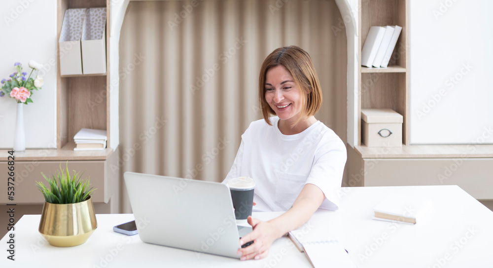 Young female student sitting at the desk at home and preparing for a new academic year. Education and online training concept Young female student sitting at the desk at home and preparing for a new academic year. Education and online training concept