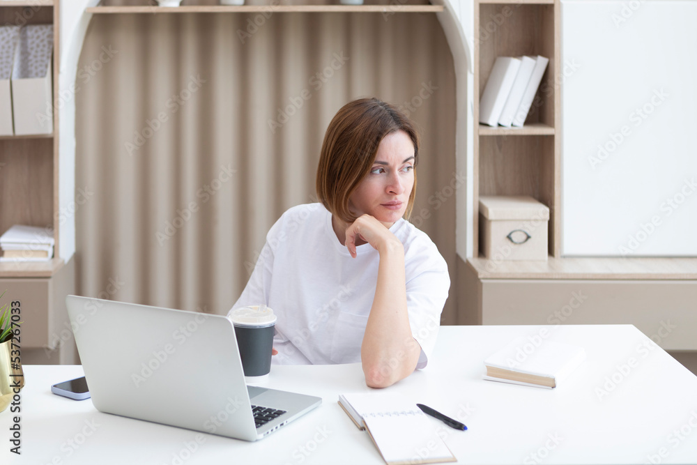 Young female student sitting at the desk at home and preparing for a new academic year. Education and online training concept Young female student sitting at the desk at home and preparing for a new academic year. Education and online training concept