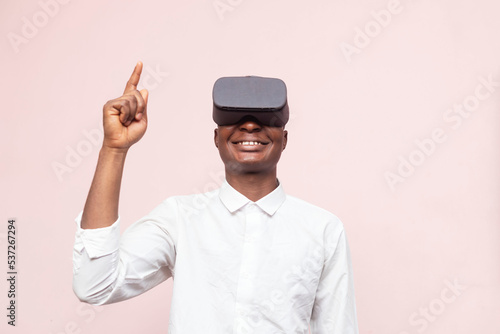 young african businessman pointing one finger up while wearing a modern virtual reality