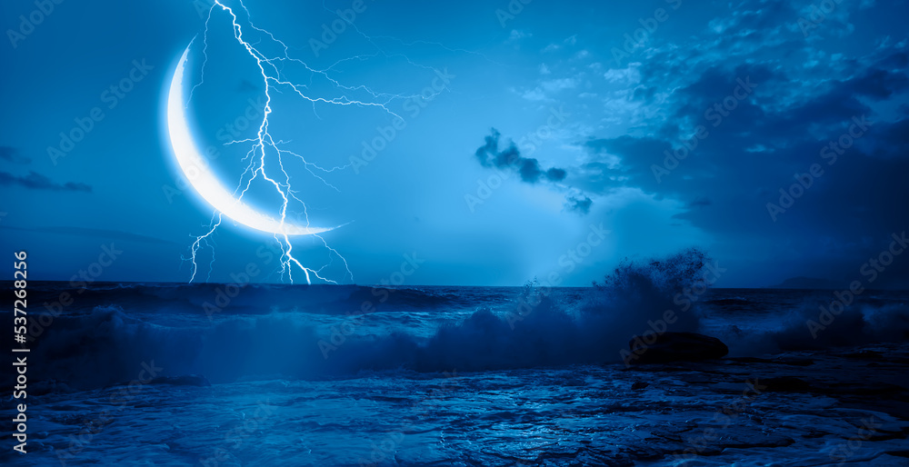 Night sky with lightning on crescent moon in the clouds on the fore ground calm blue sea Night sky with lightning on crescent moon in the clouds on the fore ground calm blue sea