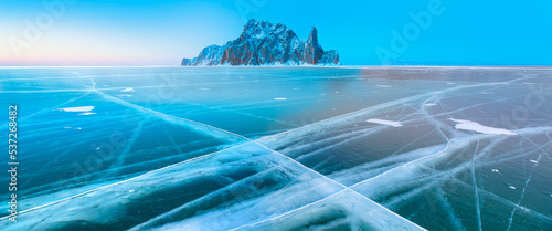 Ogoy island on winter Baikal lake with transparent cracked blue ice at sunrise - Baikal, Siberia, Russia