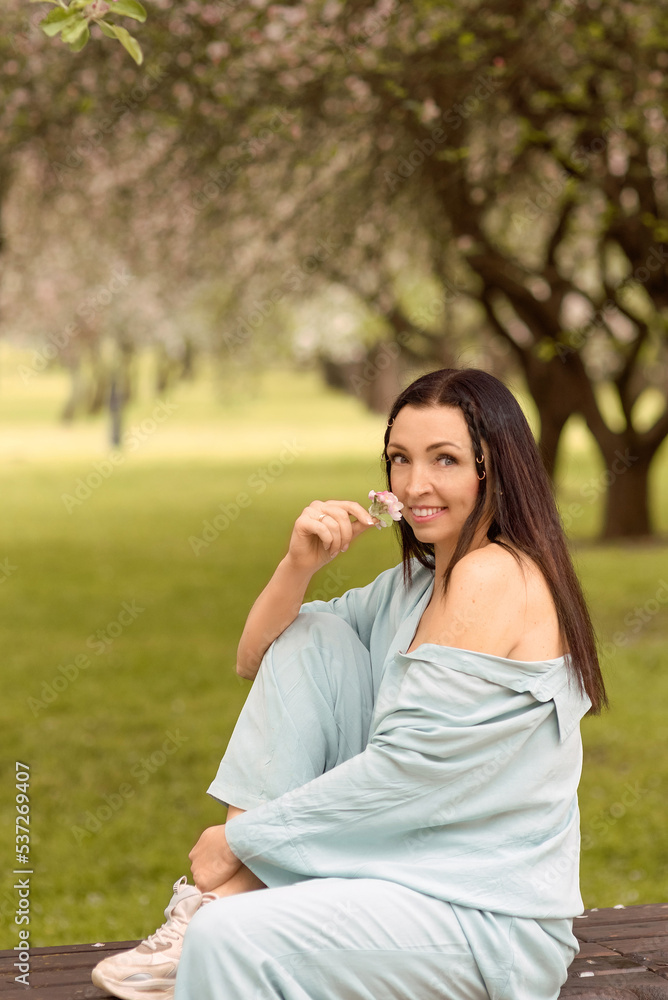 girl with long dark hair in spring blooming garden
girl with long dark hair in spring blooming garden