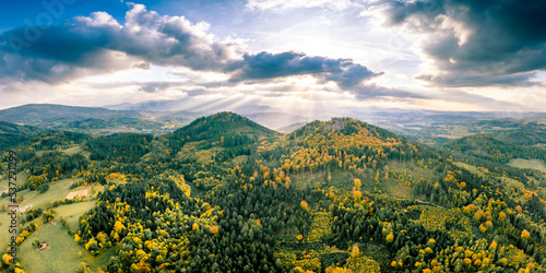 Sunrays over a picturesque landscape aerial panorama of Rudawy Janowickie mountains.