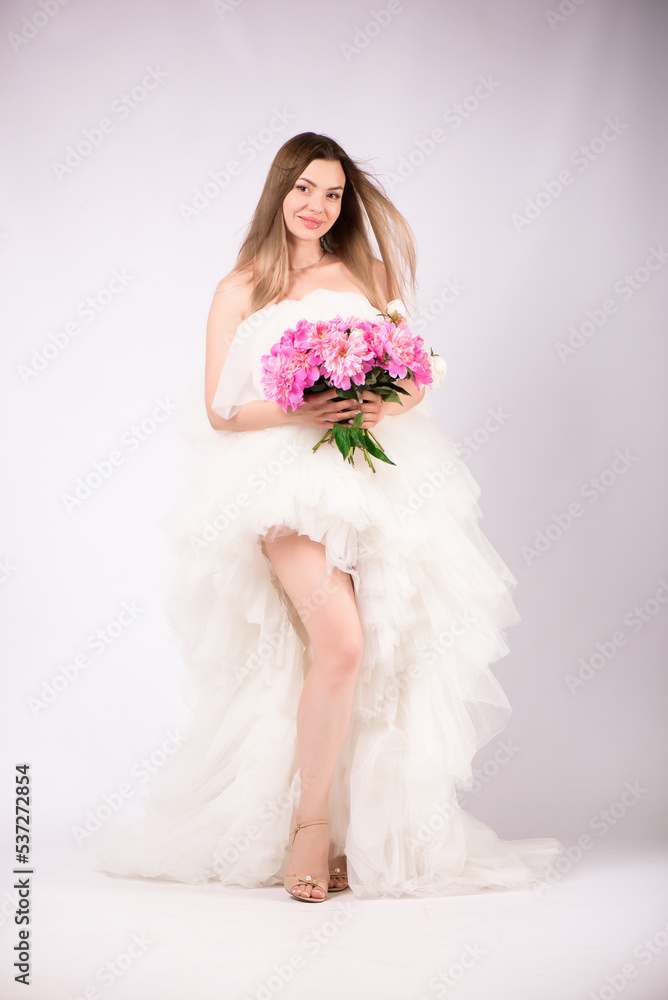Beautiful smiling woman with a wreath of peonies on the head Beautiful smiling woman with a wreath of peonies on the head