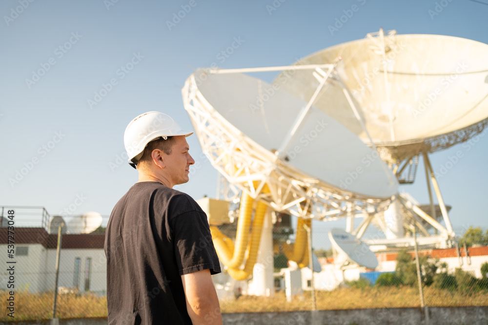 Engineer looking earth based astronomical radio telescope