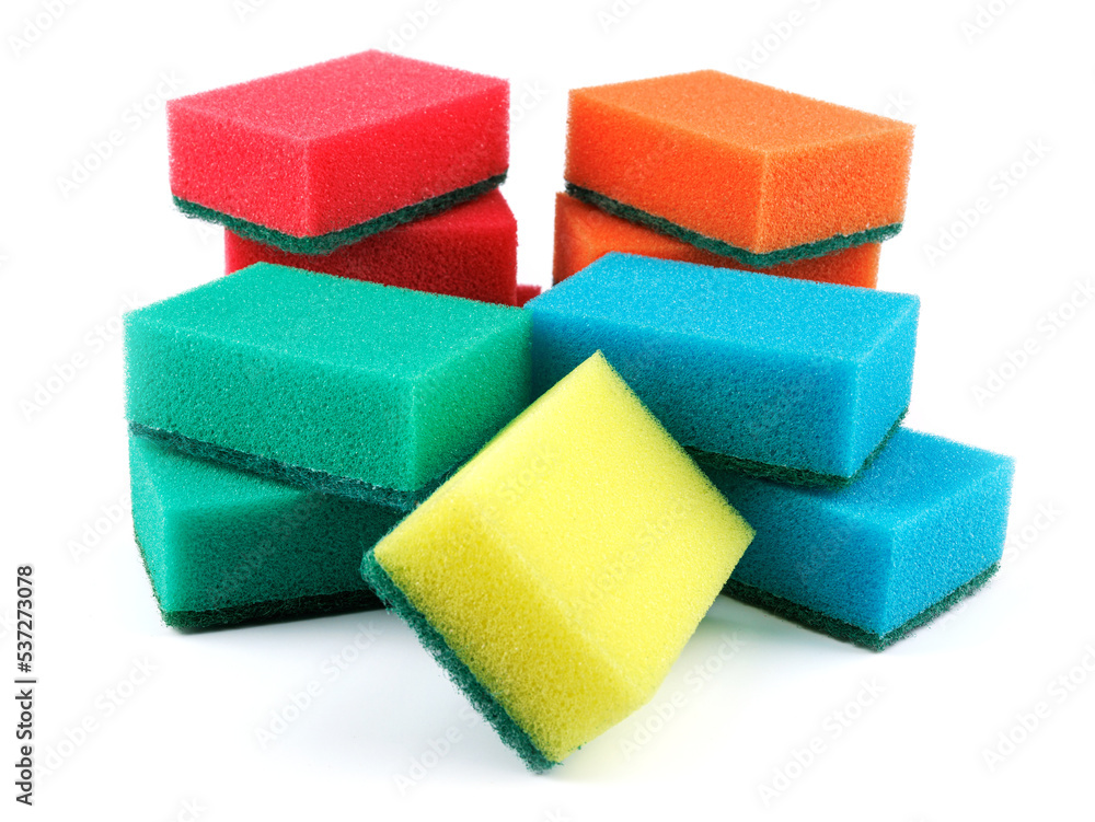 Several multi-colored sponges isolated on a white background. Sponge for washing dishes . Several multi-colored sponges isolated on a white background. Sponge for washing dishes .