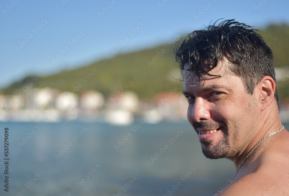 portrait of a man sitting on the beach